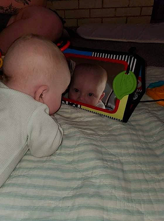 Morgan is registered to the contest to win money with this photo: baby, baby_products, baby_toddler_clothing, bedtime, cheek, child, comfort, eye, facial_expression, flooring, fun, human_body, iris, linens, mammal, mouth, person, room, sitting, skin