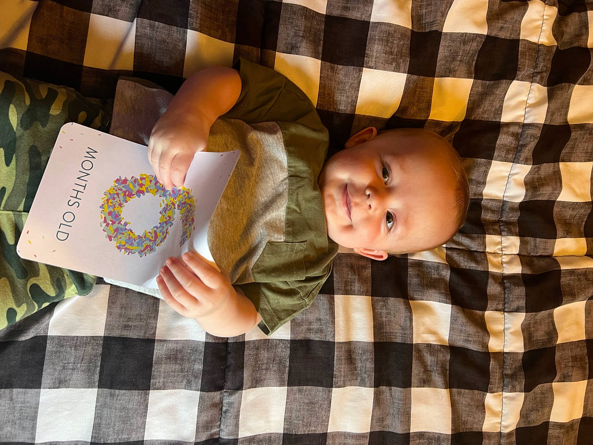 Hudson joined the competition — help win amazing prizes! baby, baby_toddler_clothing, book, child, comfort, design, finger, hand, linens, nail, pattern, person, plaid, room, sitting, sleeve, tartan, textile, toddler, wood