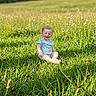 Annabelle joined the competition — help win amazing prizes! toddler, child, grass, ladybug, meadow, wildflowers, sunlight, outdoor, nature, greenery, smile, happy, summer, field, baby, short_sleeve_shirt, sitting, plants, daylight, portrait