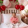 Kataleya participe au concours pour gagner de l'argent avec cette photo : baby, child, bed, balloons, cherry, pink, blanket, pajamas, smiling, happy, indoors, celebration, birthday, decorations, window, curtains, potted_plant, cup, table, cute
