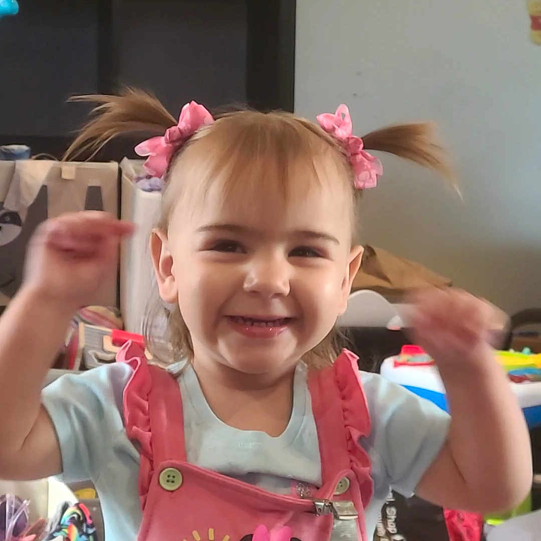 Melody is registered to the contest to win money with this photo: accessories, bodypart, child, clothing, face, female, furniture, girl, hair, happy, head, indoors, laughing, mouth, person, photography, portrait, smile, t_shirt, teeth