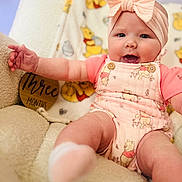 Allieanne is registered to the contest to win money with this photo: baby, infant, child, pink_bow, smile, winnie_the_pooh, onesie, soft_chair, cute, happy, three_months, headband, chubby_cheeks, sitting, indoors, plush, cozy, portrait, clothing, baby_girl