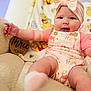 baby, infant, child, pink_bow, smile, winnie_the_pooh, onesie, soft_chair, cute, happy, three_months, headband, chubby_cheeks, sitting, indoors, plush, cozy, portrait, clothing, baby_girl