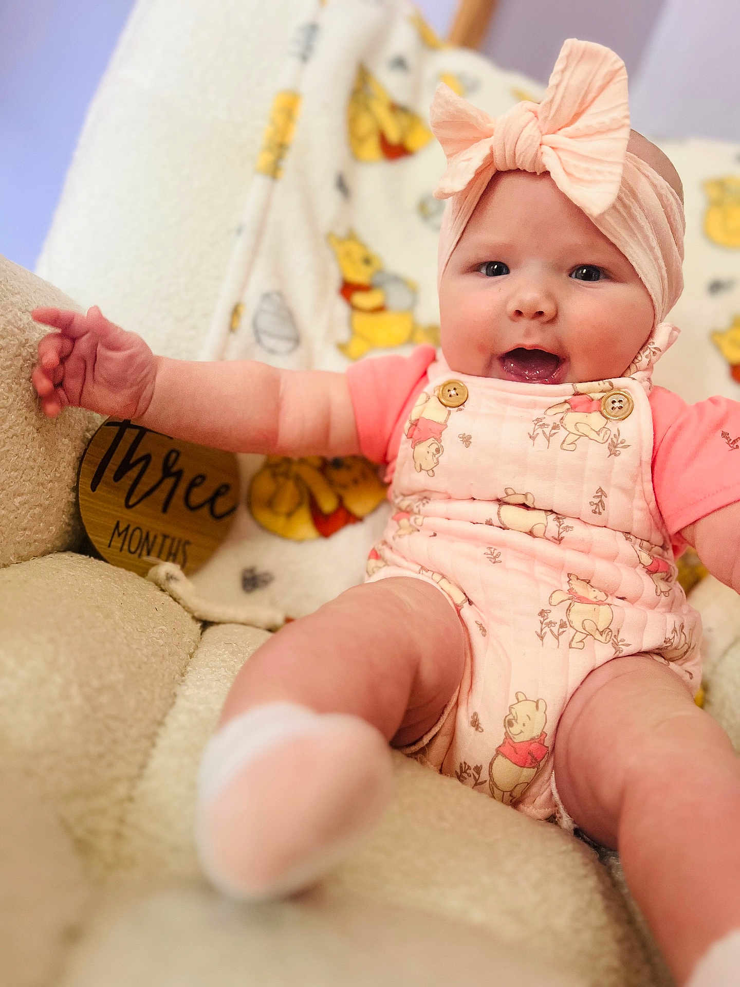 Allieanne is registered to the contest to win money with this photo: baby, infant, child, pink_bow, smile, winnie_the_pooh, onesie, soft_chair, cute, happy, three_months, headband, chubby_cheeks, sitting, indoors, plush, cozy, portrait, clothing, baby_girl