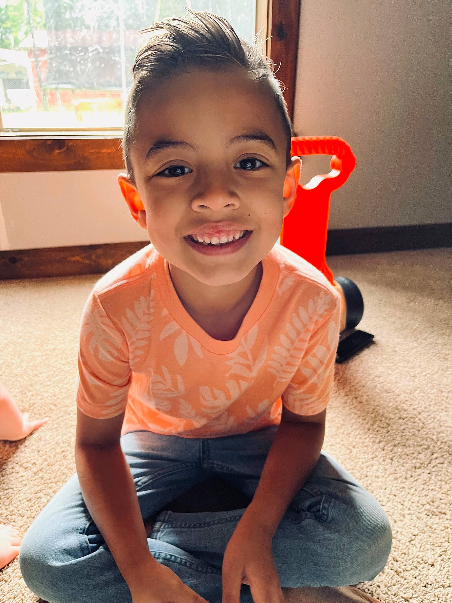 Dalton is registered to the contest to win money with this photo: child, chin, flooring, fun, happy, head, human_leg, joy, knee, leisure, mouth, neck, nose, person, shoe, sitting, skin, smile, sneakers, t_shirt