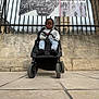 Lucas-Joao Zayn a rejoint le concours — aidez-le/la à gagner de superbes lots ! baby, banner, building, child, clothing, crowd, daytime, gate, historic, hoodie, iron_fence, outdoor, pavement, people, sign, street, stroller, toddler, urban, walking