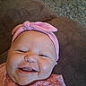 Sophia joined the competition — help win amazing prizes! baby, infant, child, smiling, happy, portrait, close_up, pink_headband, bow, floral_clothing, couch, indoor, face, eyes, nose, mouth, laughing, sitting, soft_lighting, home