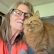 Lucy joined the competition — help win amazing prizes! woman, glasses, orange_shirt, cat, orange_cat, fluffy_cat, indoor, selfie, face, pet, feline, happy, closeup, human, animal, affection, cute, companion, friendship, casual