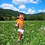 Tao a rejoint le concours — aidez-le/la à gagner de superbes lots ! toddler, child, field, meadow, wildflowers, greenery, nature, outdoor, sky, clouds, hills, bandana, diaper, smiling, happy, grass, sunny, daytime, boots, portrait