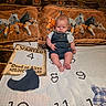 Asstro joined the competition — help win amazing prizes! baby, bed, blanket, child, clothing, face, home_decor, horse_pattern, horses, indoor, infant, numbers, overalls, photography, pillow, portrait, rustic, serious, sitting, wanted_poster
