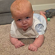 Asstro is registered to the contest to win money with this photo: baby, bib, carpet, child, crawling, eyes, face, green_ball, home, indoors, infant, living_room, photography, portrait, sitting, smiling, sofa, toy, tummy_time, white_clothing