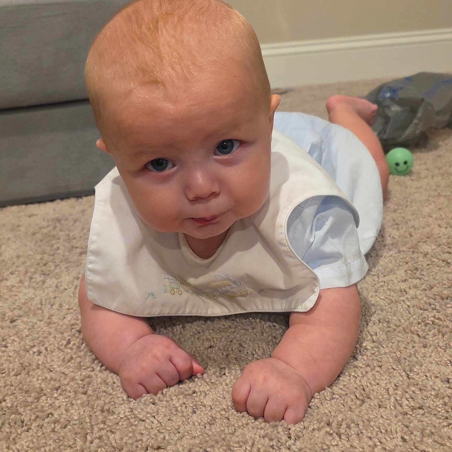 Asstro is registered to the contest to win money with this photo: baby, bib, carpet, child, crawling, eyes, face, green_ball, home, indoors, infant, living_room, photography, portrait, sitting, smiling, sofa, toy, tummy_time, white_clothing