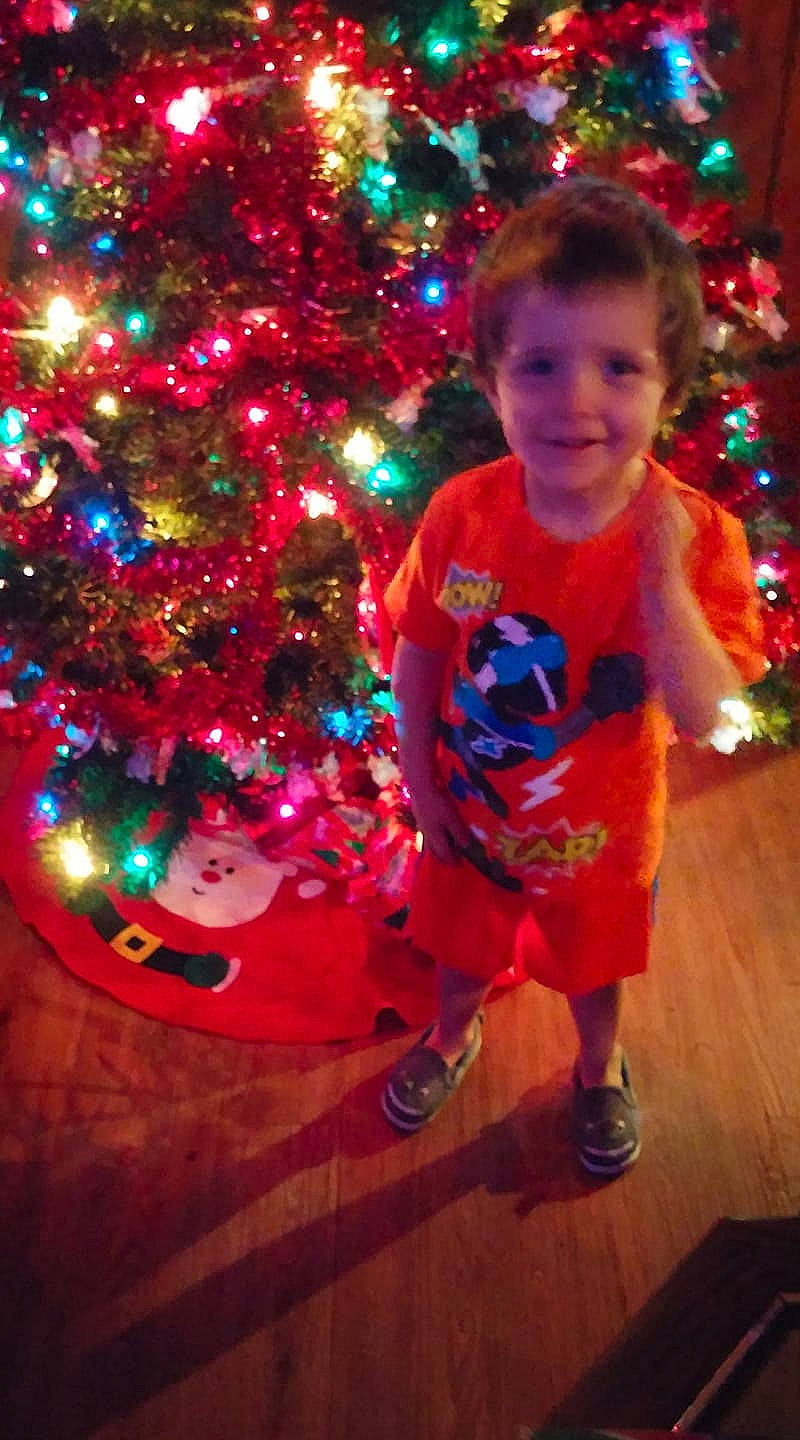Brayden is registered to the contest to win money with this photo: child, christmas, christmas_decoration, christmas_eve, christmas_lights, christmas_ornament, christmas_tree, conifer, event, fir, happy, holiday, holiday_ornament, interior_design, joy, ornament, person, pine_family, plant, smile