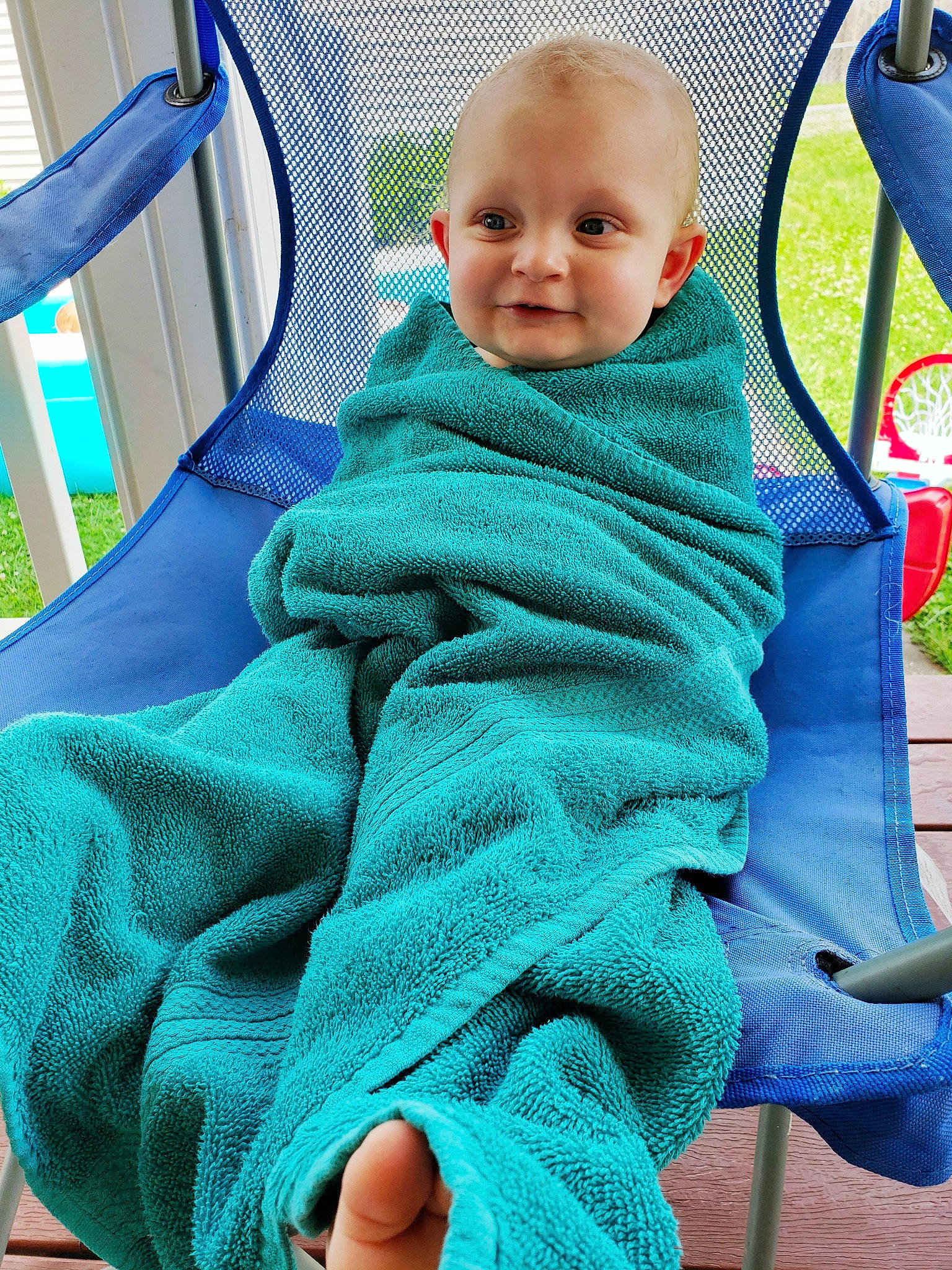 Konner is registered to the contest to win money with this photo: baby, blanket, blue, child, knitting, outerwear, person, play, product, sitting, smile, textile, toddler, turquoise, wool