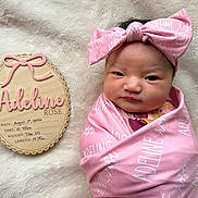 Adeline joined the competition — help win amazing prizes! baby, newborn, infant, pink_blanket, headband, wooden_plaque, birth_details, name_tag, soft_texture, fluffy_blanket, portrait, cute, wrapped, lying_down, indoor, closeup, child, adorable, peaceful, newborn_photography