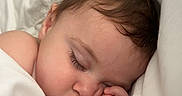 Aurora is registered to the contest to win money with this photo: baby, bed, blanket, child, closeup, comfort, cozy, cute, eyelashes, face, hand, head, infant, peaceful, portrait, rest, skin, sleeping, soft, white