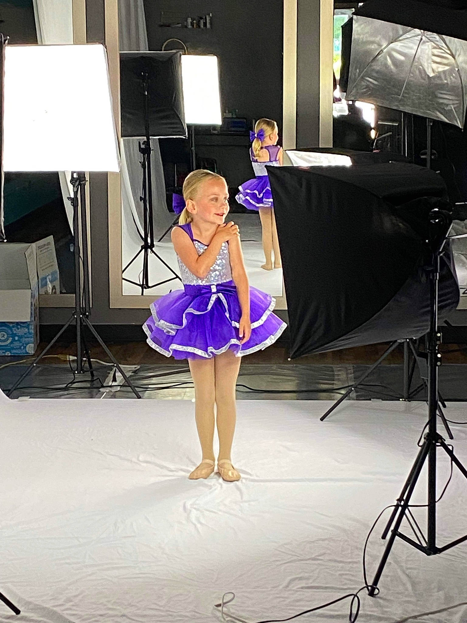 Ember is registered to the contest to win money with this photo: artist, costume, dance, display_device, electric_blue, electronic_device, entertainment, event, fashion, fashion_design, human_leg, performance, performance_art, performing_arts, person, purple, smile, stage, stage_equipment, technology