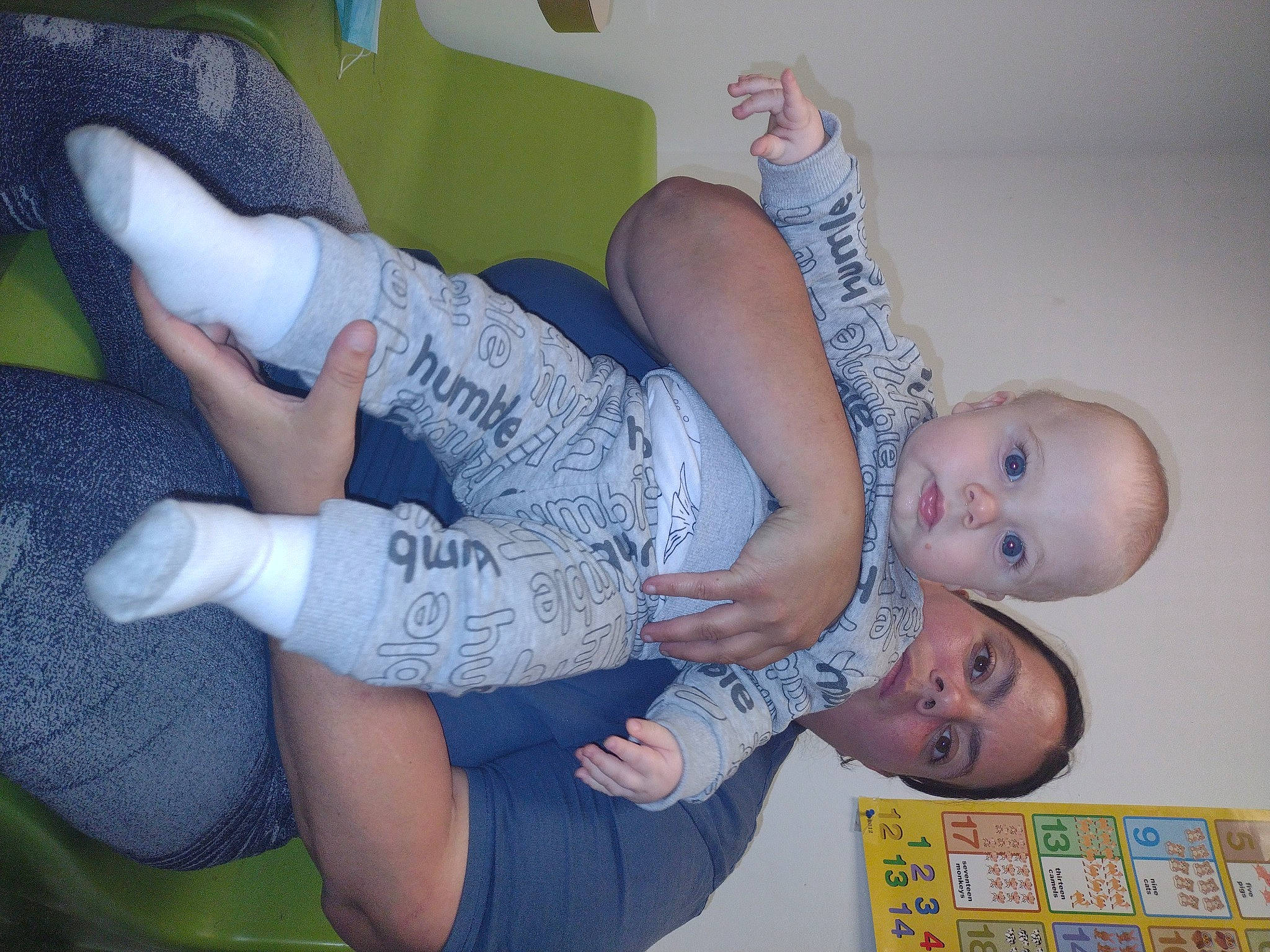 Marcellus is registered to the contest to win money with this photo: arm, baby, comfort, elbow, facial_expression, finger, gesture, hand, happy, human_body, joint, knee, leg, mouth, nail, person, product, textile, thigh, thumb