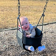 Wrenley Rose joined the competition — help win amazing prizes! baby, swing, playground, child, smiling, happy, outdoor, sunny, blue_sky, grass, wood_chips, clothing, sock, face, person, daytime, park, fun, seat, chain
