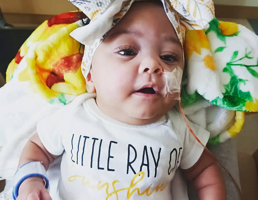 Rae'Lyn is registered to the contest to win money with this photo: baby, baby_toddler_clothing, cheek, eye, eyelash, face, gesture, happy, head, headgear, jaw, lip, mouth, people, person, sleeve, smile, t_shirt, textile, toddler