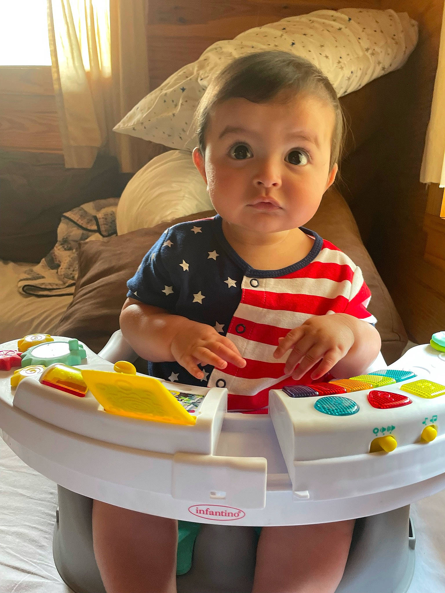 Huxley is registered to the contest to win money with this photo: baby, baby_products, baby_toddler_clothing, child, comfort_food, curtain, eating, facial_expression, food, fun, happy, icing, junk_food, lamp, party, person, play, room, sitting, surprise
