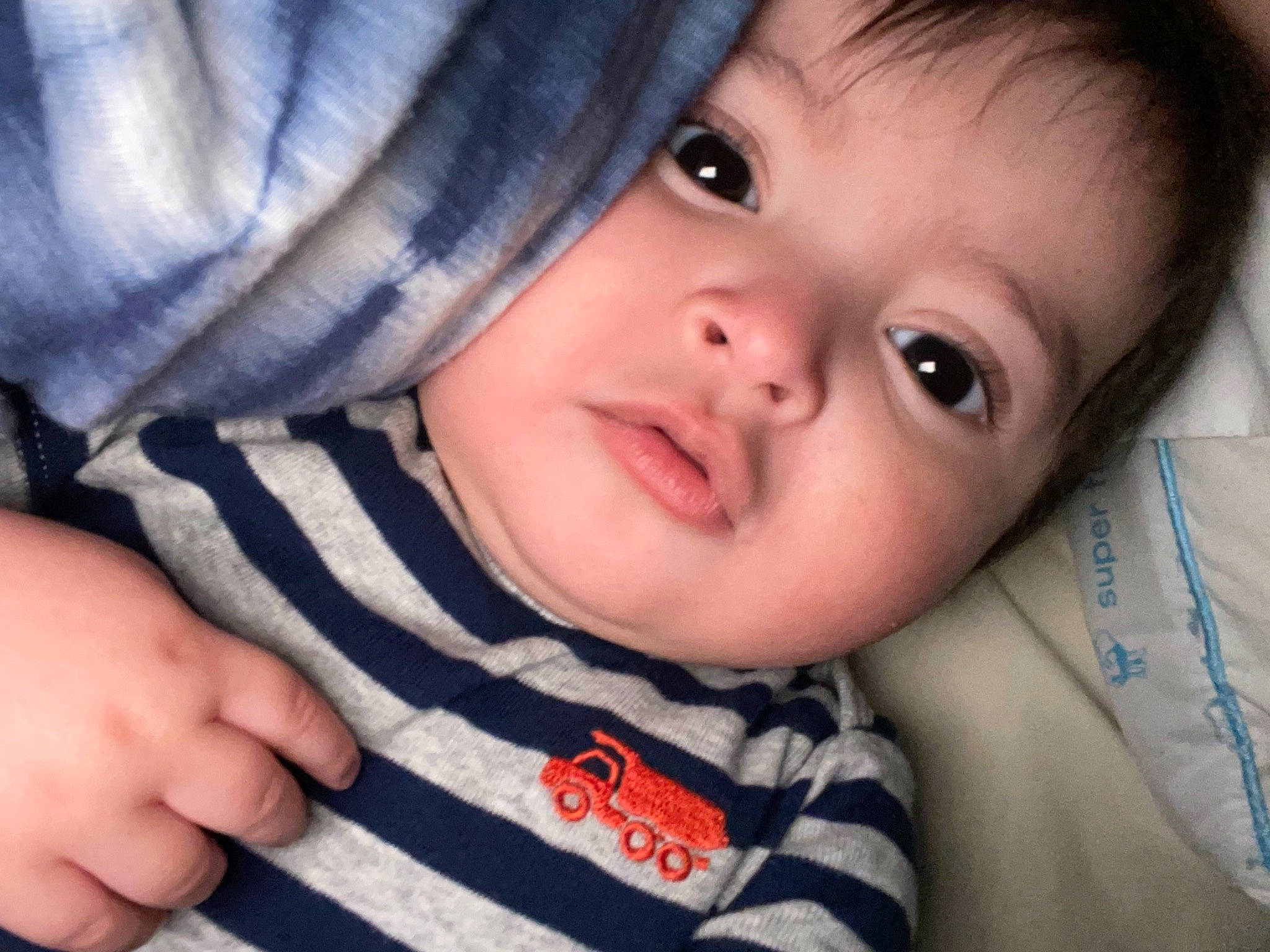 Huxley is registered to the contest to win money with this photo: azure, baby, cheek, child, ear, eyebrow, eyelash, finger, flash_photography, gesture, happy, human, iris, lip, nose, person, skin, sleeve, smile, thumb