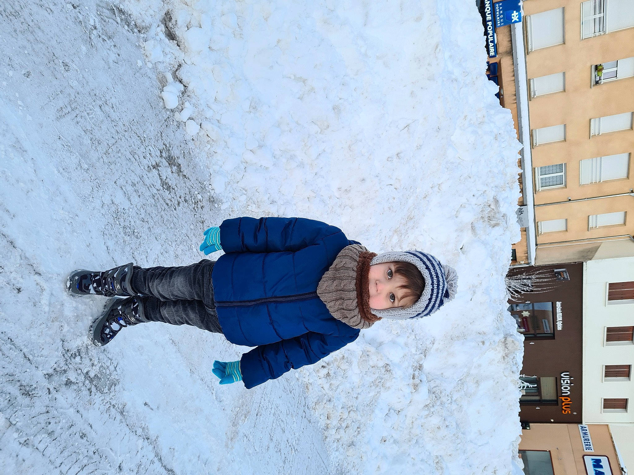 Sebastian participe au concours pour gagner de l'argent avec cette photo : blue, building, city, concrete, electric_blue, freezing, fun, headwear, leisure, person, play, precipitation, recreation, shadow, sidewalk, slope, snow, street, toddler, water
