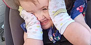 Adalyn is registered to the contest to win money with this photo: car_interior, car_seat, child, clothing, cute, dress, face, floral_pattern, fun, hair_tied, happy, person, playful, safety_harness, seat, seatbelt, smiling, socks, toddler, young_girl