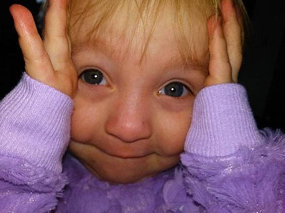 Emilee is registered to the contest to win money with this photo: cheek, child, chin, close_up, ear, eye, eyebrow, face, finger, forehead, hand, head, human_hair_color, infant, joy, lip, mouth, nose, person, purple