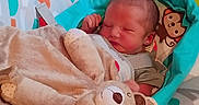 Grayson is registered to the contest to win money with this photo: newborn, baby, blanket, plush_toy, baby_seat, sleeping, infant, soft_toy, monkey_print, cozy, child, resting, cute, indoors, comfort, colorful, fabric, head, peaceful, toddler