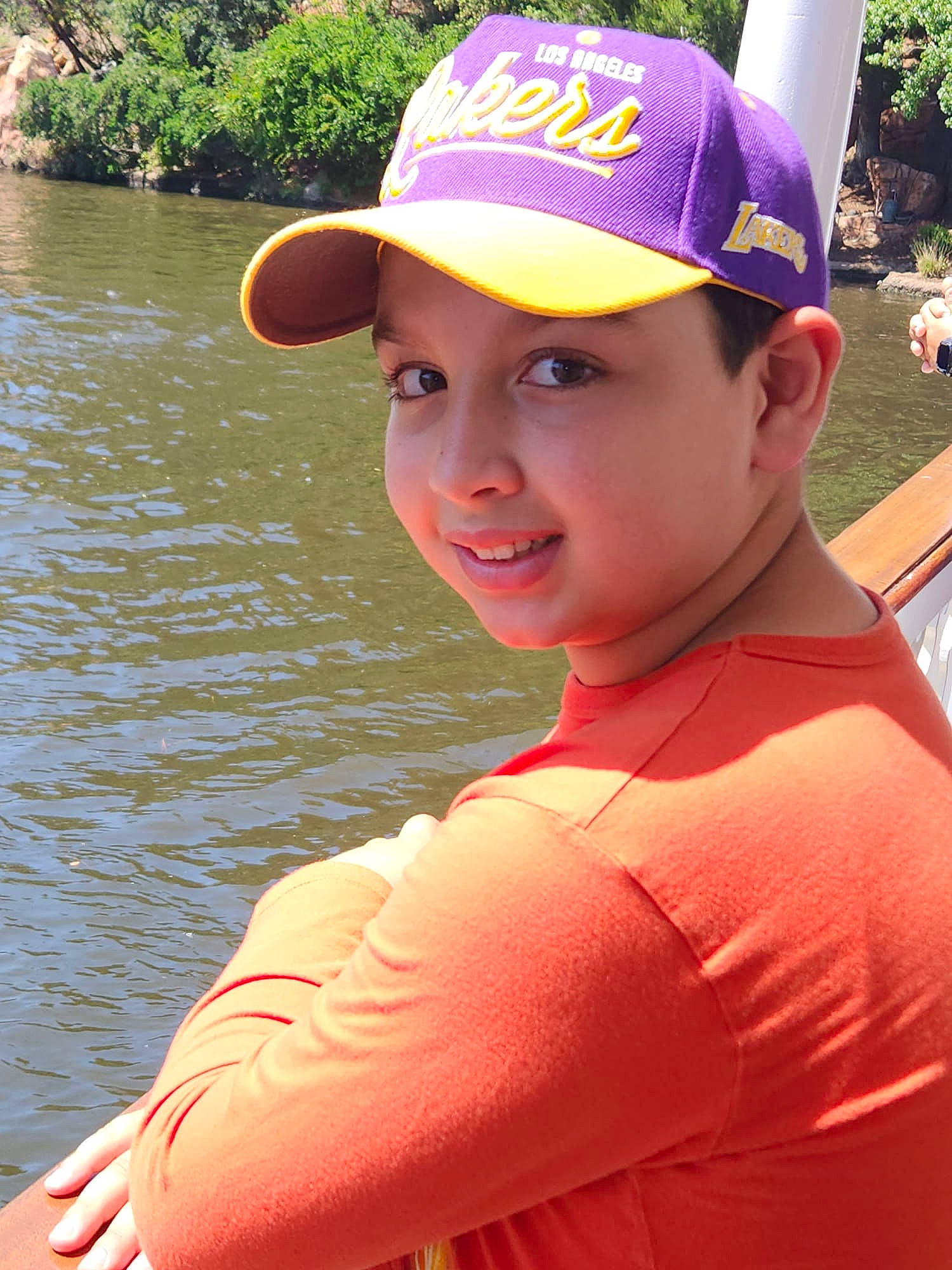 Bryan joined the competition — help win amazing prizes! baseball_cap, cap, child, electric_blue, fashion_accessory, fun, happy, hat, headgear, headwear, lake, leisure, people, person, personal_protective_equipment, pink, recreation, smile, t_shirt, travel