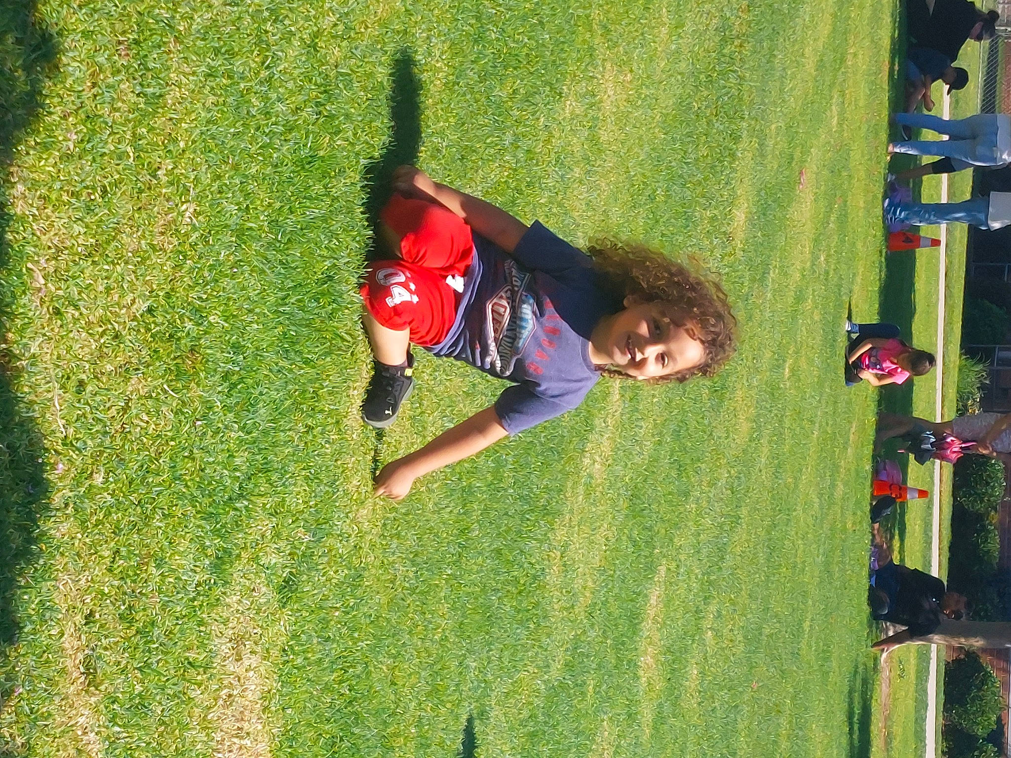 Jayden is registered to the contest to win money with this photo: baby, competition_event, flooring, fun, games, grass, grass_family, grassland, green, joy, lawn, leisure, people_in_nature, person, plant, player, recreation, sport_venue, sports, t_shirt