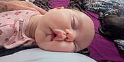 Fenn is registered to the contest to win money with this photo: baby, sleeping, person, bed, blanket, dog, hand, pajamas, room, purple_bedspread, tattoo, socks, furniture, pet, comfort, sleep, indoor, cozy, relaxation, home