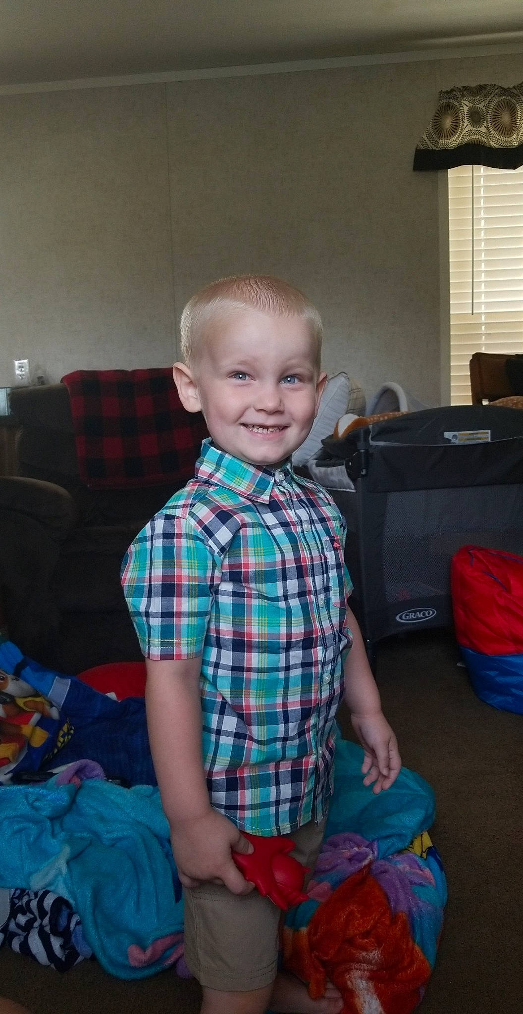 William is registered to the contest to win money with this photo: blue, boy, child, day, eye, fun, hair, hairstyle, human_hair_color, joy, organ, pattern, person, plaid, product, sitting, skin, smile, standing, tartan