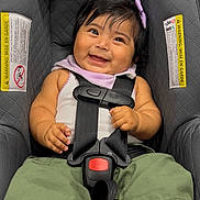 Skyler joined the competition — help win amazing prizes! baby, car_seat, smiling, child, purple_bow, green_pants, white_top, pink_shoes, nike, plush_toys, safety_harness, infant, cute, happy, indoor, portrait, seatbelt, child_seat, black_hair, playful