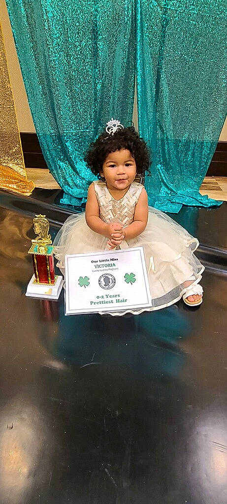 Skylynn Fay joined the competition — help win amazing prizes! blue, bridal_accessory, ceremony, child, curtain, dress, event, fashion_accessory, fashion_design, figurine, formal_wear, fun, gown, happy, headpiece, jewellery, person, sitting, toddler, tradition