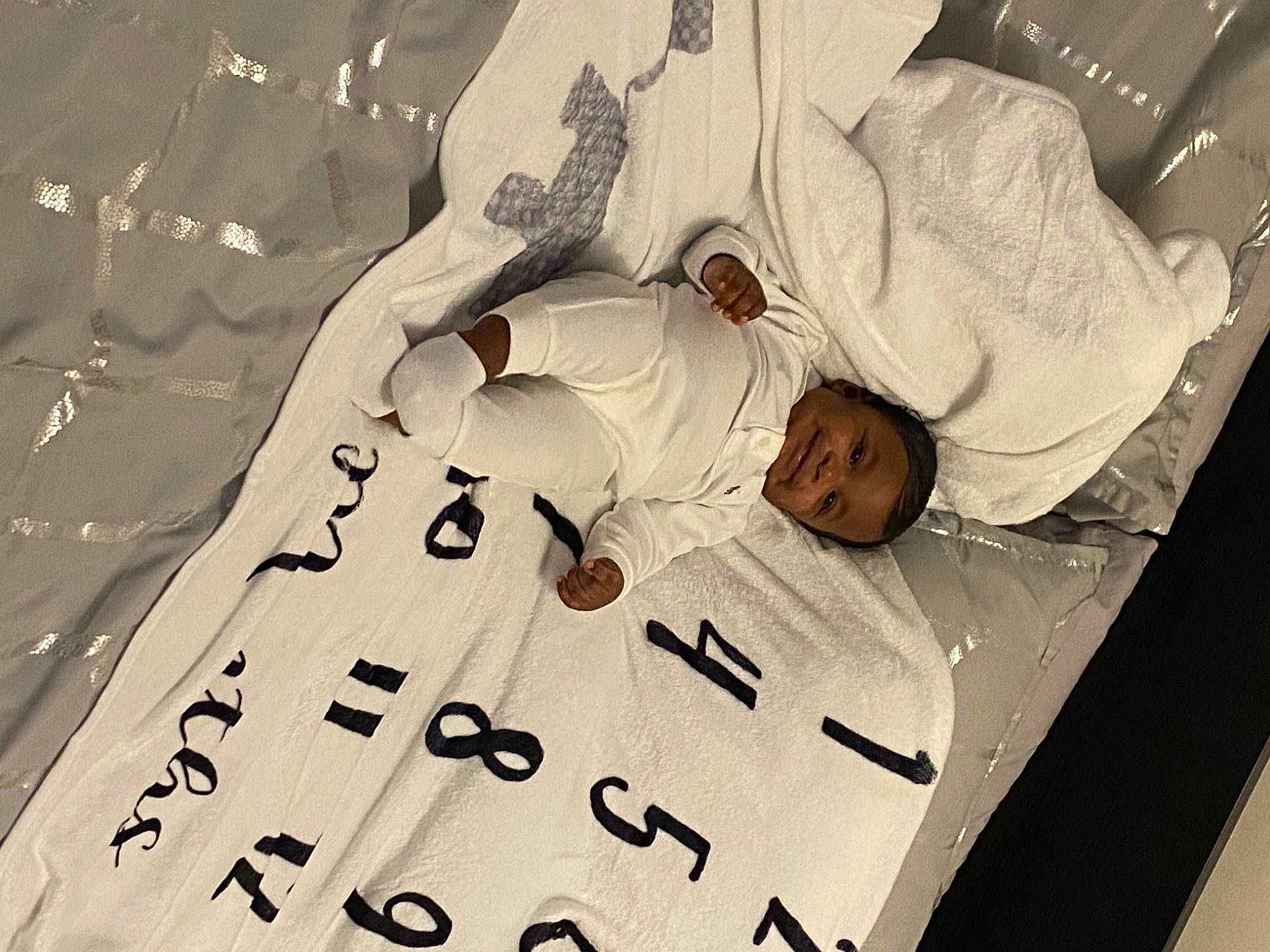 Diallo is registered to the contest to win money with this photo: art, baby, bed, bedding, card_game, carmine, child, comfort, event, font, happy, joy, linens, number, paper, pattern, person, room, sleeve, t_shirt