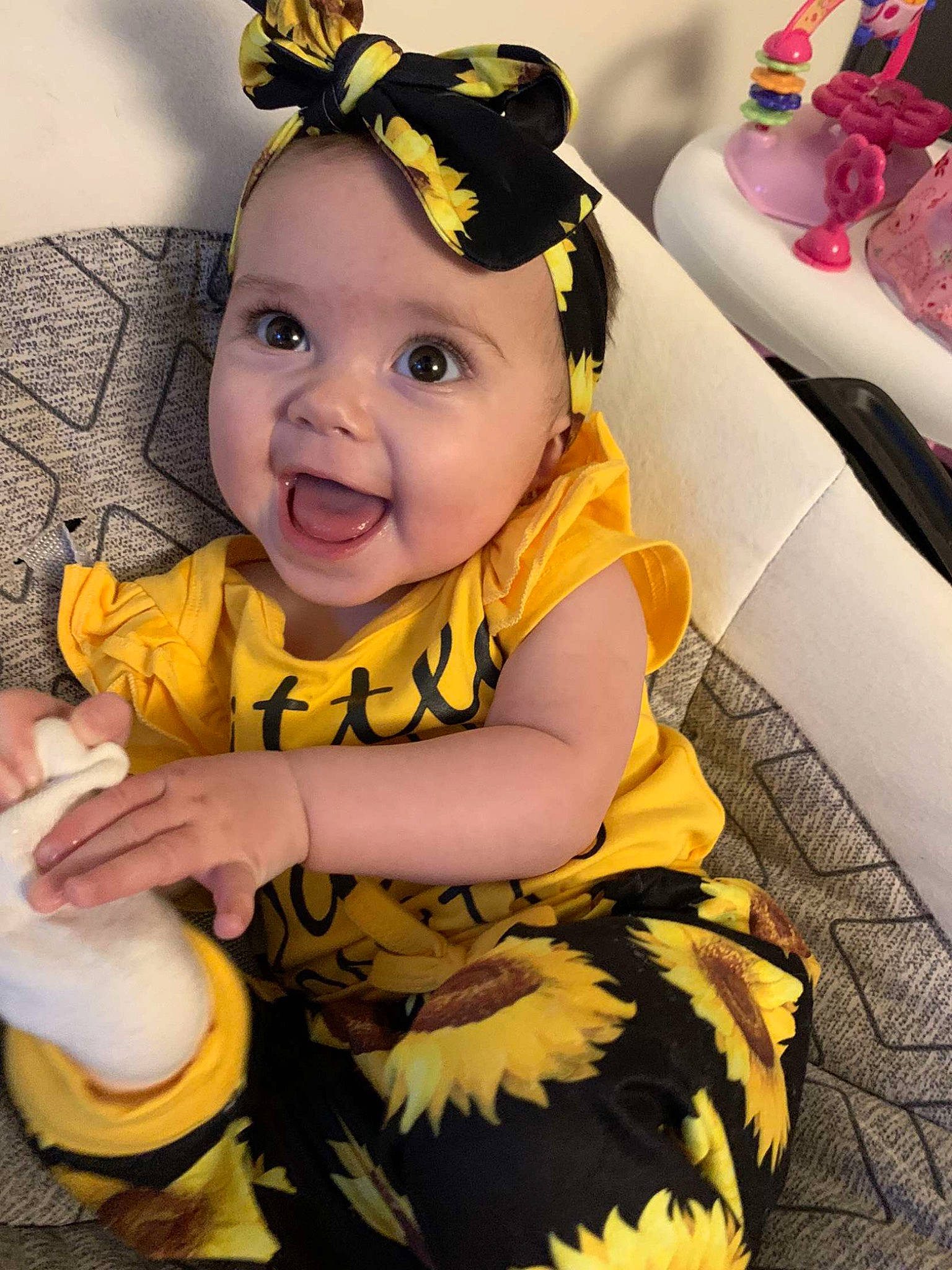 Jaylee is registered to the contest to win money with this photo: baby, baby_products, baby_toddler_clothing, child, costume, costume_hat, eye, face, facial_expression, happy, headgear, headwear, pattern, person, pink, product, sitting, skin, sleeve, smile