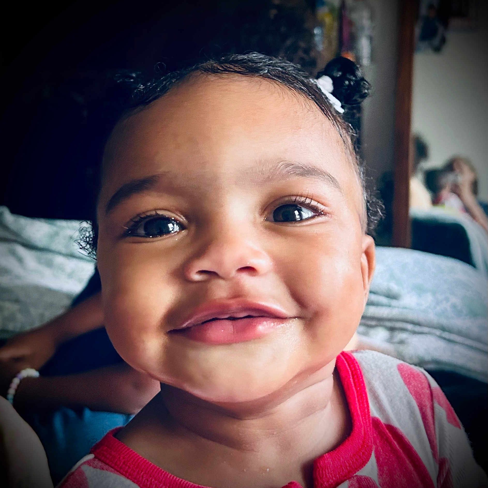 Naima joined the competition — help win amazing prizes! baby, child, closeup, clothing, cute, expression, eyes, face, hair, happy, indoors, joy, person, pigtails, portrait, red, skin, smiling, toddler, white