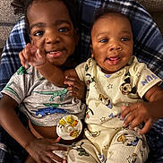 Kaysyn is registered to the contest to win money with this photo: toddler, baby, child, smiling, happy, dinosaur_shirt, mickey_mouse_pajamas, blanket, couch, indoor, playful, cute, sibling, family, portrait, clothing, two_children, infant, closeup, cozy