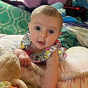 Ryleigh joined the competition — help win amazing prizes! baby, infant, child, face, eyes, arm, blanket, plush_toy, cushion, bed, clothing, patterned, indoor, cute, expression, soft, colorful, toy, person, portrait