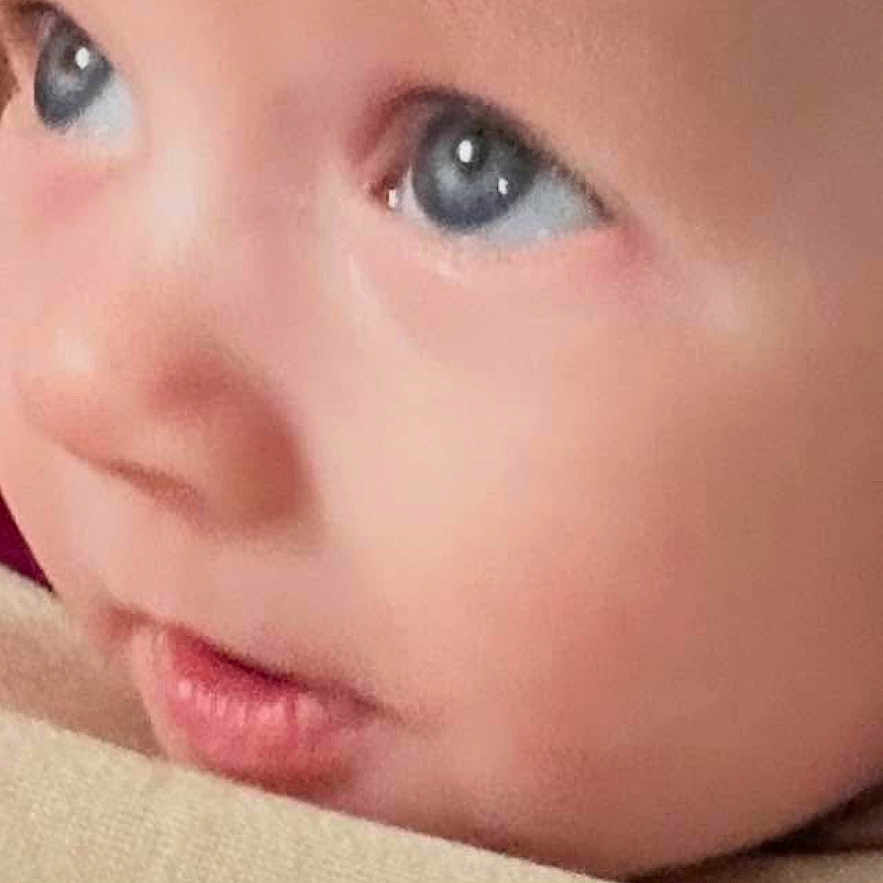 Caz is registered to the contest to win money with this photo: baby, face, close_up, blue_eyes, infant, child, skin, portrait, social_media, comment_section, likes, profile_picture, text, digital, screenshot, mobile_screen, expression, cute, young, human