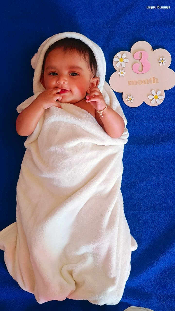 Ditvi joined the competition — help win amazing prizes! baby, infant, towel, blue_blanket, smiling, face, portrait, cute, child, milestone, 3_month, flower, decor, wrapped, skin, hand, lying_down, soft, cozy, happy