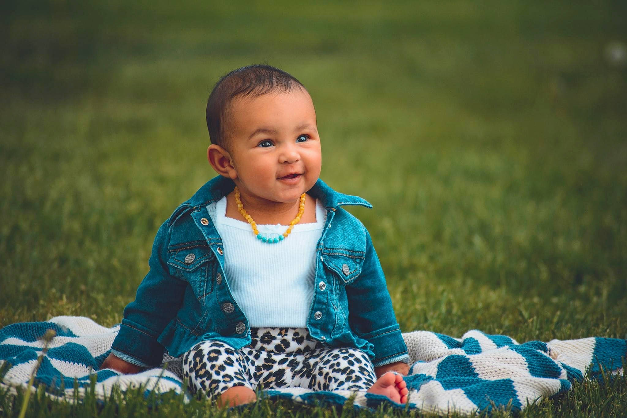 Cordelia is registered to the contest to win money with this photo: baby, blue, cheek, child, eye, face, facial_expression, grass, grass_family, green, happy, head, joy, people, person, photograph, photography, sitting, skin, smile