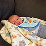 animal_print, baby, bib, blanket, child, clothing, comfort, couch, cozy, cute, expression, face, indoor, infant, person, portrait, resting, soft, striped_pants, young