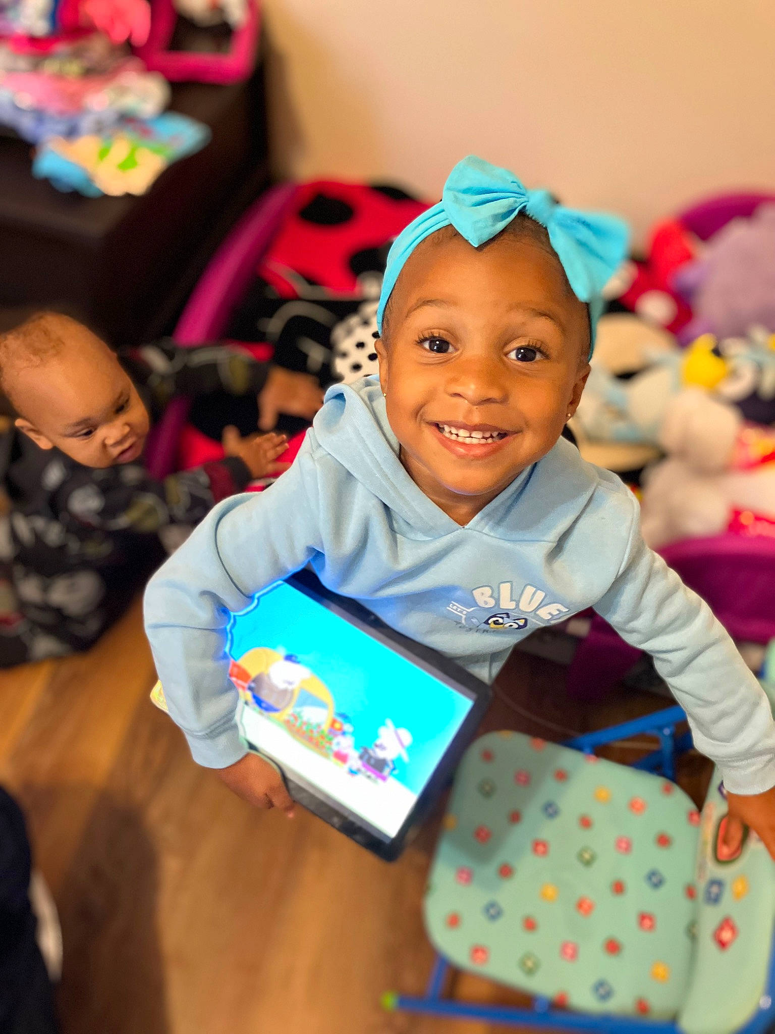 Aubrey is registered to the contest to win money with this photo: baby, child, event, face, facial_expression, fun, happy, human, joy, kindergarten, leisure, magenta, party, pattern, person, play, recreation, room, sitting, skin