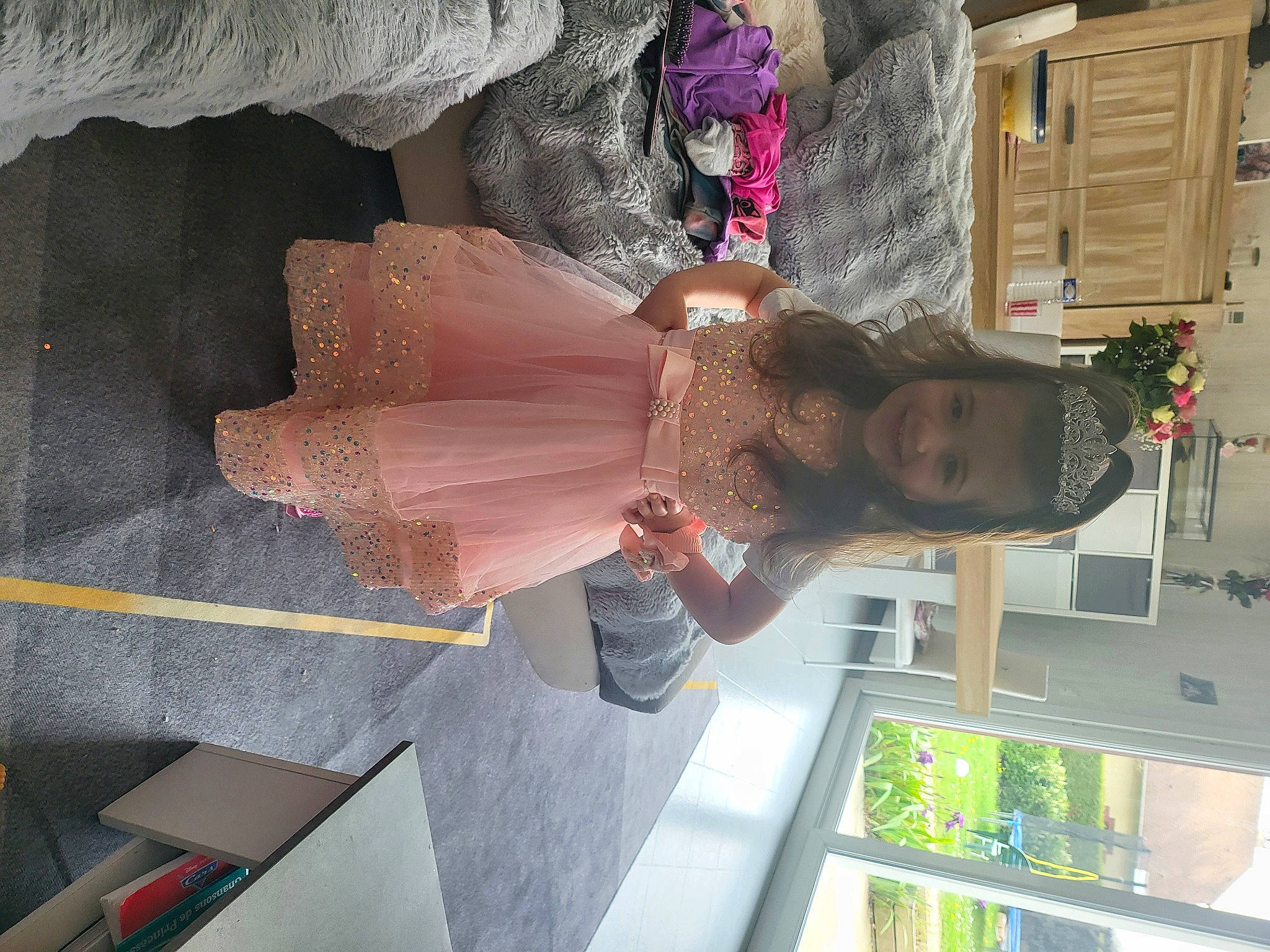 Lyana participe au concours pour gagner de l'argent avec cette photo : dress, fashion_design, flesh, fun, joy, peach, person, pink, plant, room, smile, snapshot, toy, visual_arts, wedding_dress, window, wrist