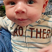 Diego joined the competition — help win amazing prizes! baby, infant, face, eyes, smile, hand, clothing, onesie, zipper, striped, text, brother, fabric, soft, indoor, cute, child, person, portrait, close_up