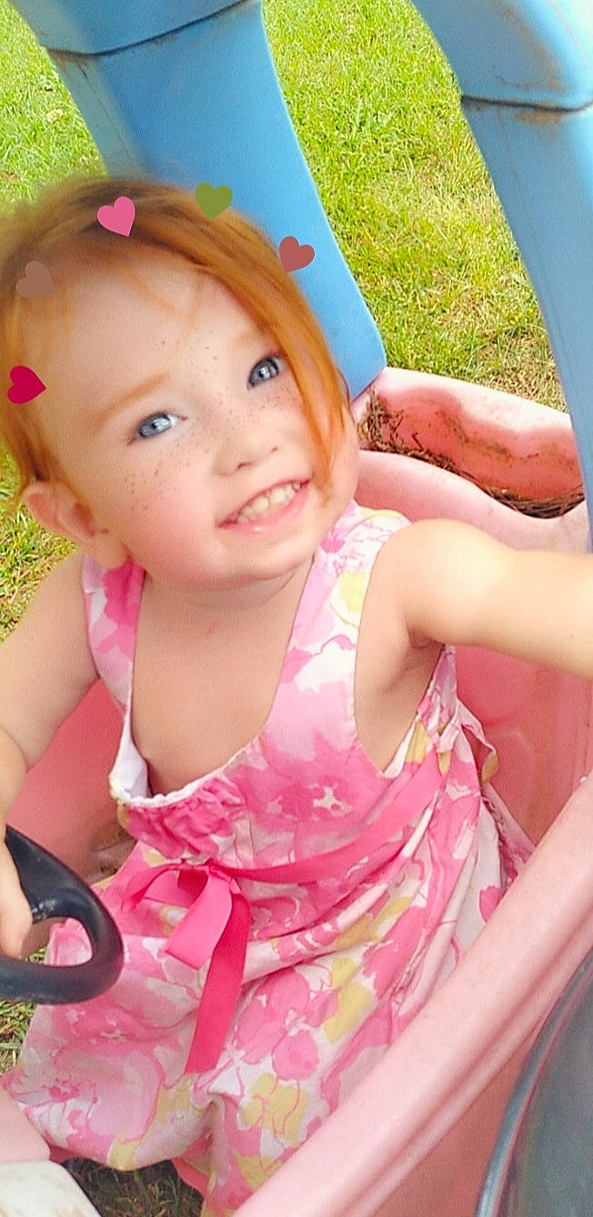 Annalee is registered to the contest to win money with this photo: baby_toddler_clothing, beauty, child, fashion_accessory, finger, fun, grass, green, happy, joy, leisure, lip, magenta, pattern, people_in_nature, person, pink, recreation, skin, smile