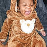 Phaylon is registered to the contest to win money with this photo: baby, child, infant, smiling, laughing, portrait, onesie, bear_costume, hood, plush, brown_clothing, sitting, indoor, blanket, close_up, face, happy, cute, phone_photography, watermark